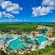 Aerial view of Kuzá Beach & Adventure Park featuring large pools, colorful waterslides and lush jungle scenery